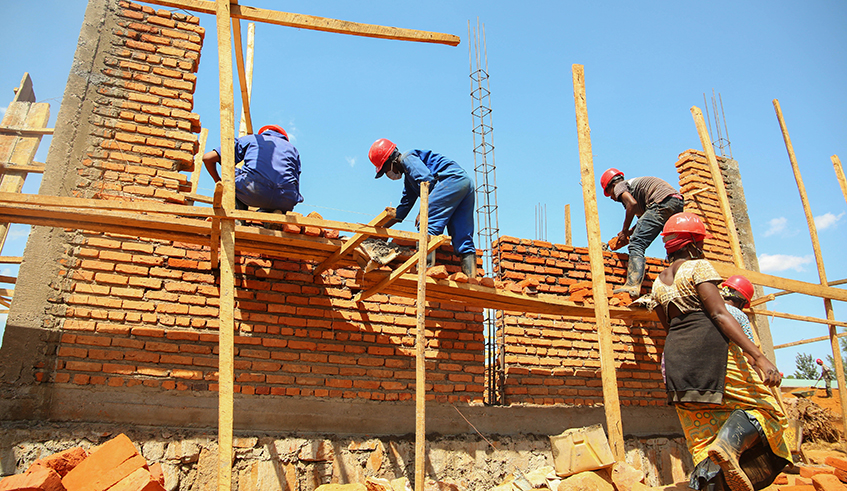 Workers during the construction activities of new classrooms at Groupe Scolaire Rusheshe in Kicukiro District in May . / File