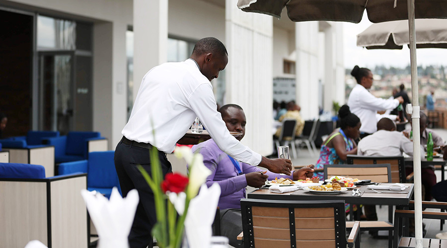 A waiter serves a client at a hotel in Kigali in January this year. 50 per cent of the Economic Recovery Fund features a hotel refinancing facility to enable the restructuring of loans held by hotels. 