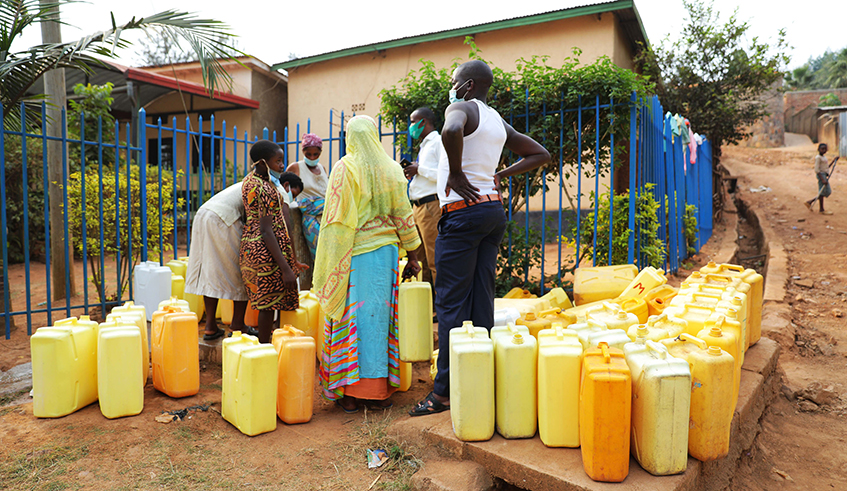 Residents of Masaka Sector in Kicukiro District queue for water at a public tap. Kigali continues to experience persistent shortage of water, particularly during the dry season. / Photo: Dan Nsengiyumva. 