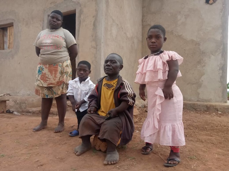Alexandre Rwamanyege (seated) and three of his five children at his home in Kiramuruzi Sector, Gatsibo District. 