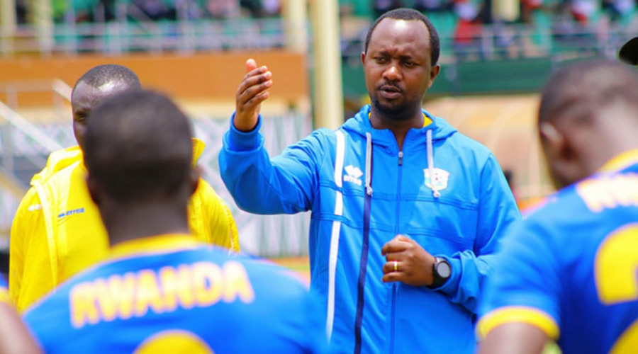 Vincent Mashami speaks to Amavubi players before leading a past training session at Kigali Stadium. 