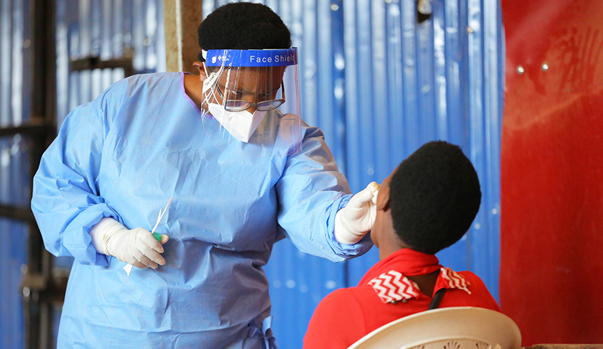 A health worker tests a randomly selected person at Nyabugogo market last week. The home-based care system, which was rolled out countrywide on Friday, August 28, will ensure majority of Covid-19 cases are isolated in their homes.  / Photo: File.