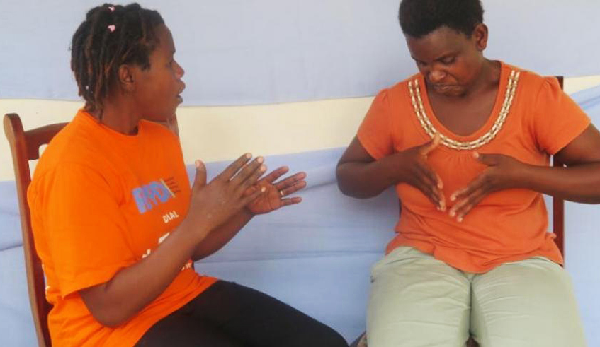 Two ladies converse through sign language in Muhanga  District . / Emmanuel Ntirenganya