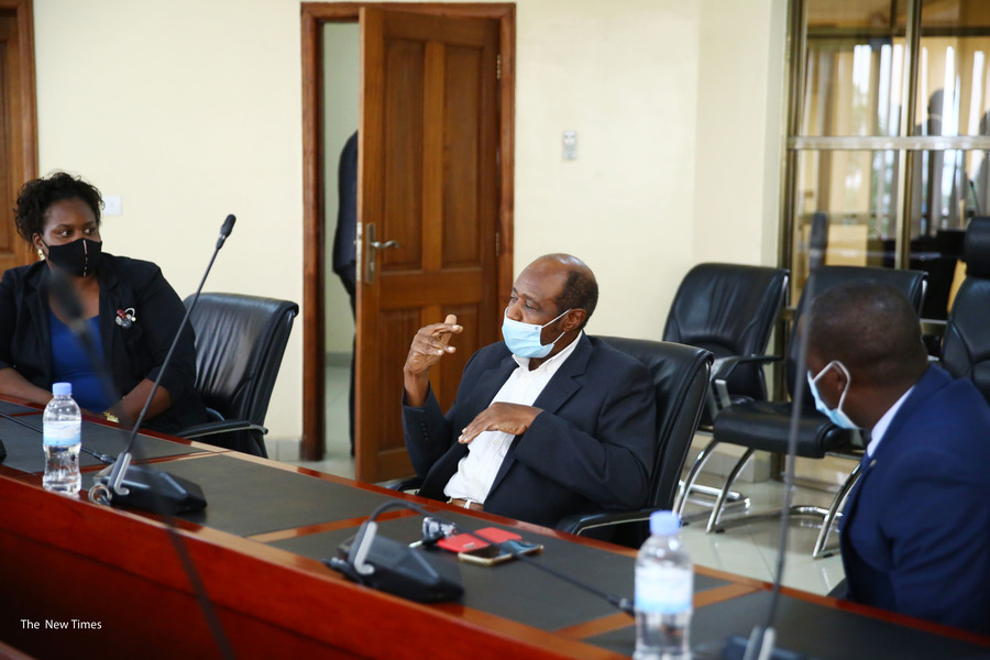 Rusesabagina interacts with his lawyers when he appeared at the headquarters of the National Public Prosecution Authority in Kimihurura on September 9. 