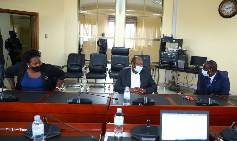 Rusesabagina interacts with his lawyers when he appeared at the headquarters of the National Public Prosecution Authority in Kimihurura on September 9. 