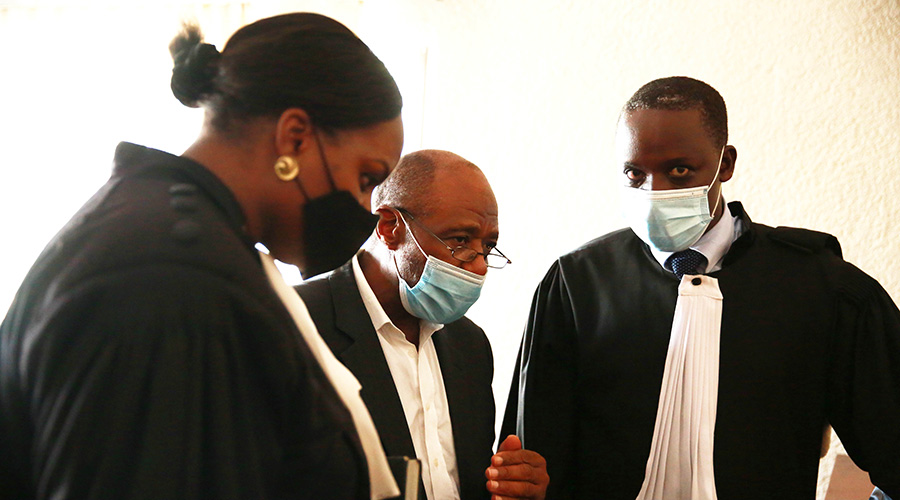 Rusesabagina interacts with his lawyers David Rugaza and Emelyne Nyumbo at Kicukiro Primary Court on 17 September, 2020. 