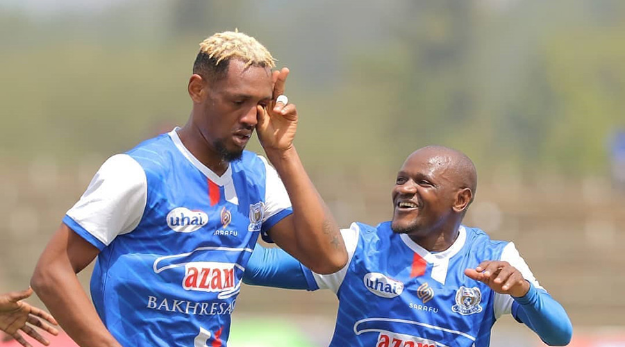 Ally Niyonzima (L) celebrates with a teammate after scoring his first goal for Azam on Sunday. 