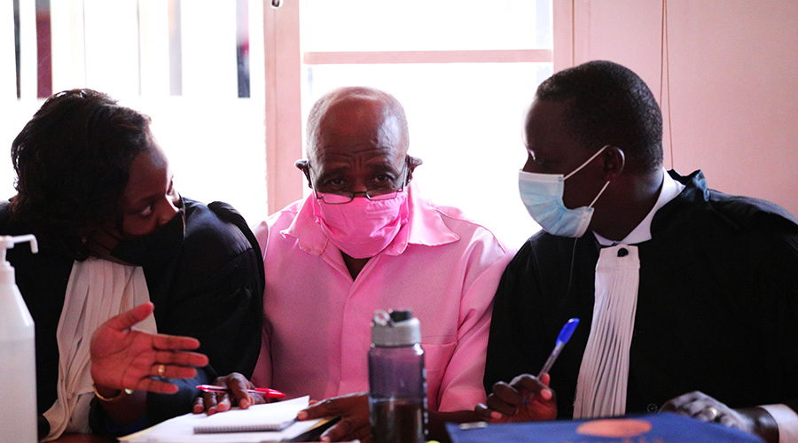 Paul Rusesabagina interacts with his lawyers during the hearing at Nyarugenge Intermediate Court on 25 September 2020. 