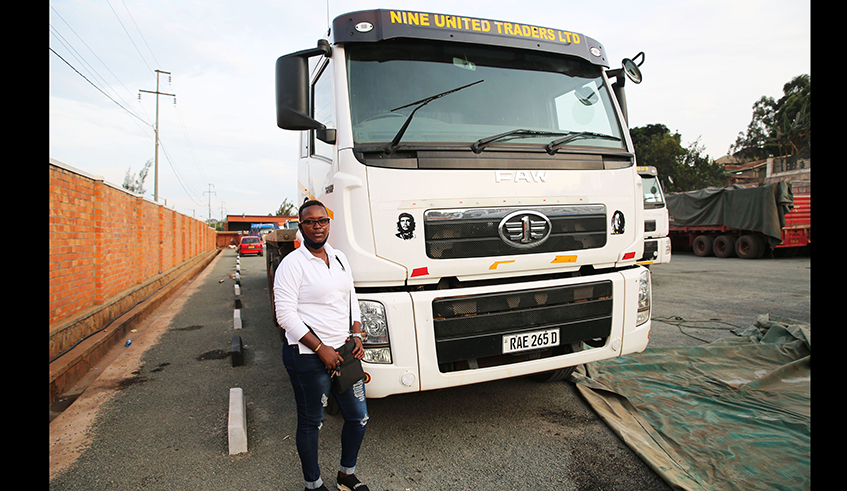 Radouce Munyakazi poses in front of a truck she drives at the premises of Nine United Traders Ltd in Kigali. Currently, there are a handful of female truck drivers in Rwanda. / Photo: Craish Bahizi.