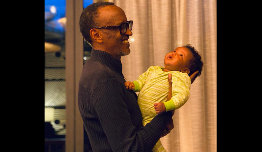 President Paul Kagame cuddles his granddaughter, the first child of First Daughter Ange I. Kagame and husband Bertrand Ndengeyingoma. / Photo: Courtesy.