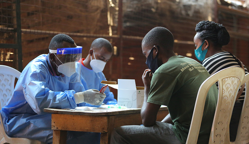Healthcare workers during a past Covid-19 testing exercise at a market in Nyabugogo, Kigali. / Photo: Dan Nsengiyumva.