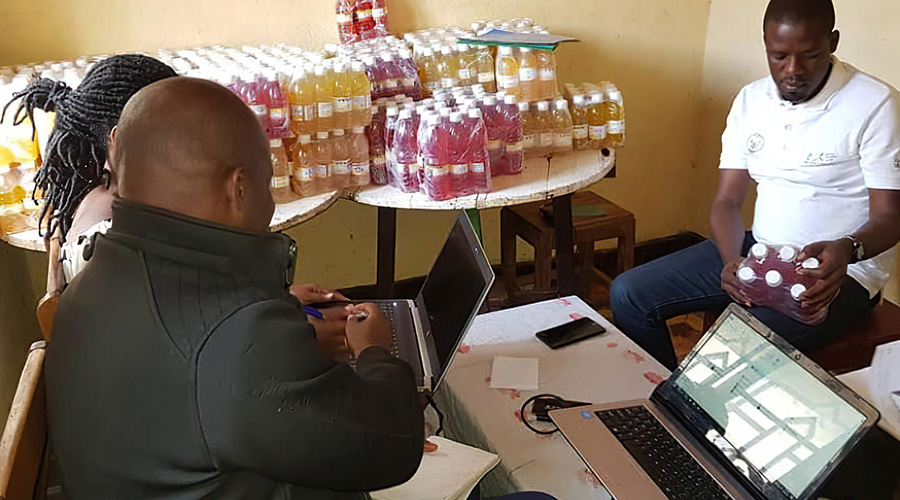 Bonaventure Niyitegeka and an employee at his multi-million fruits processing company in Ngoma District. With financial support from the Business Development Fund (BDF) in 2017, he was able to boost his companyu2019s production capacity. 