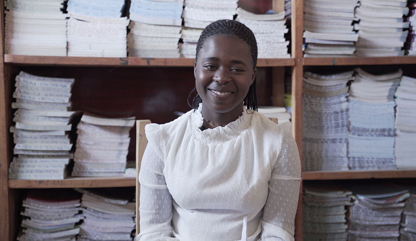 Christine Mutesi at work in the school library at Groupe Scolaire Nyarugenge in Ruhango District. According to the head teacher at the school, all teachers are enthused by Mutesiu2019s way of conducting a classroom, which is a fusion of entertainment and learning. / Photo: Gad Nshimiyimana. 