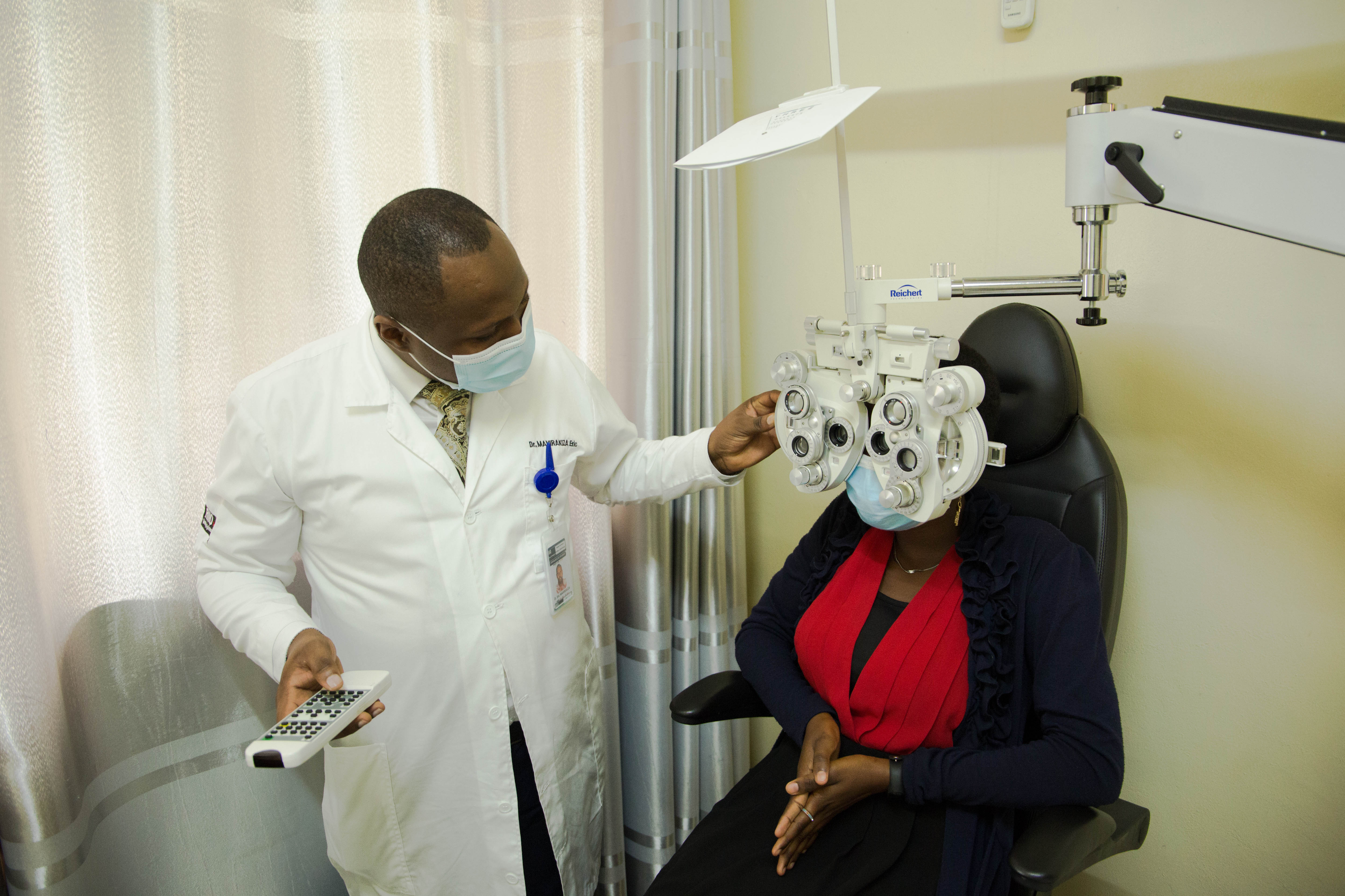 A doctor exercises a medical eye check up of patient at Kibagabaga Hospital. 