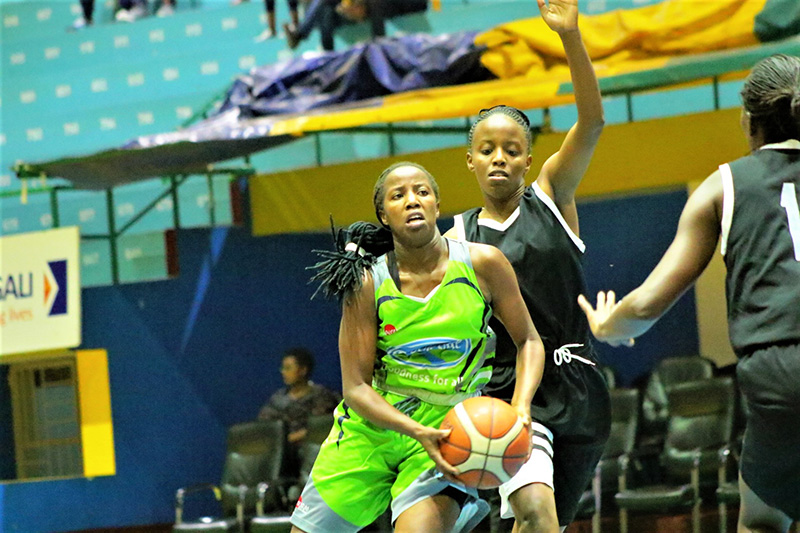 The Hoops player, Faustine Mwizerwa (with the ball), is seen here during a past league against reigning champions APR at Amahoro Indoor Stadium in Remera, Kigali. 