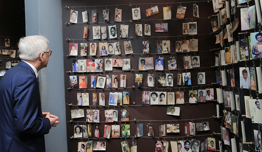A visitor looks at pictures of victims of the 1994 Genocide against the Tutsi during a tour of the Kigali Genocide Memorial. / Photo: Sam Ngendahimana.