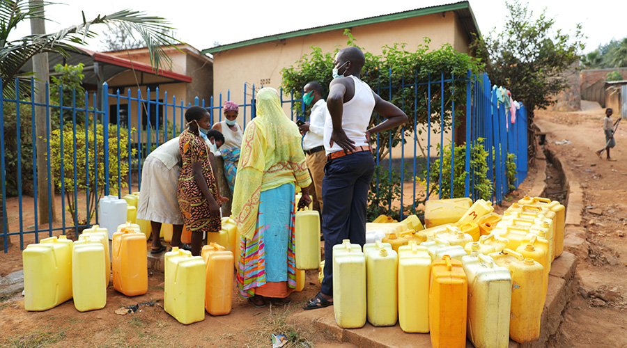 Residents fetch water. Many households still face water shortage across the country. 