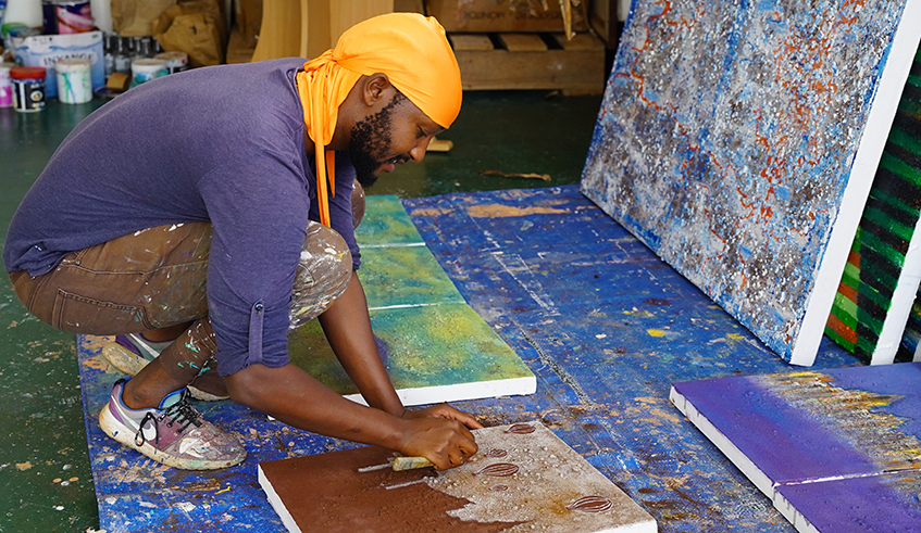 Kenneth Nkusi working on one of the paintings expected to feature at the ongoing International Balloon Museum Foundation Inaugural Exhibition taking place in the United States. / Photos : Willy Mucyo. 