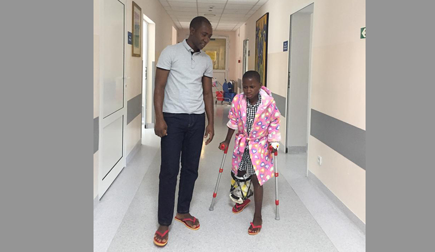 Seraphina with Modeste Habiyaremye, her helper after surgery in Poland. The little girl is now recovering with the support of the orthosis. / Photos: Courtesy