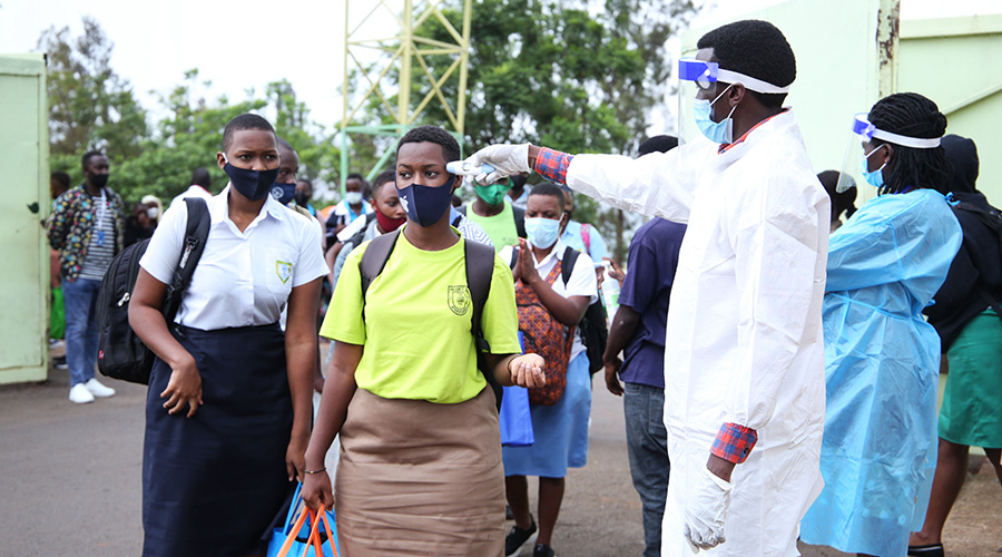 The first group of students undergo screening as they depart from Kigali Stadium in Nyamirambo heading back to their schools yesterday. 
