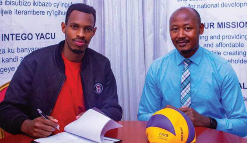 Wycliff Dusenge pens his two-year deal with Rwanda Energy Group Volleyball Club as the corporation's Human Resource Director Geoffrey Zawadi looks on, in Kigali, on Monday. / Courtesy