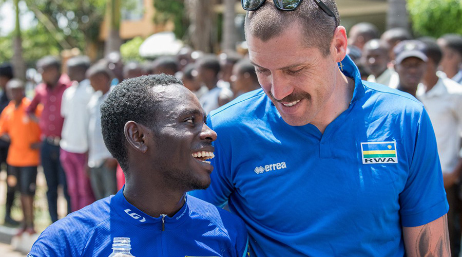 Sterling Magnell speaks to Rwandau2019s elite rider Jean-Claude Uwizeyimana during a past race. The American tactician has been head coach of the national cycling team since 2015. 