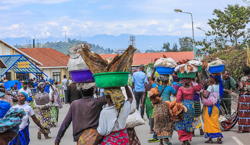 Pedestrians carry mechandise at the Rubavu-Goma border post, commonly known as u2018Petite Barriu00e8reu2019 before the Covid-19 outbreak. / Photo: File.