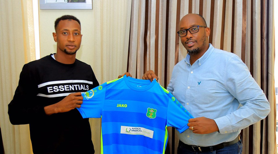 Aboubakar Lawal (L) completed his two-year move to AS Kigali on Friday, October 6. On right is Fabrice Shema, President of the club. 