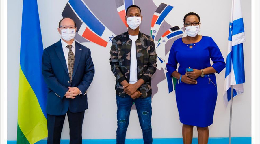 Ron Adam, the Israeli Ambassador to Rwanda, and gospel singer Israel Mbonyi (C). 