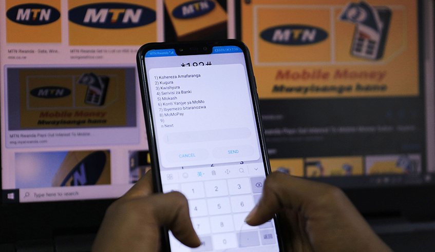 A client uses a mobile money platform. Various tech enthusiasts have welcomed the move by MTN Rwanda to launch its mobile money API. / Photo: Sam Ngendahimana.