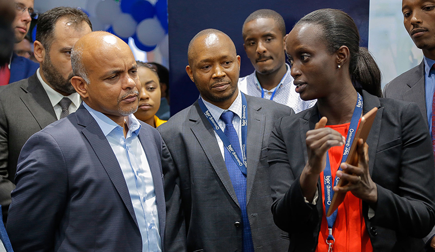 Banque Populaire du Rwanda officials follow the banku2019s technician explaining how digital financial services help their clients. / Photo: Courtesy.