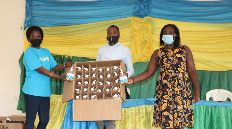 L-R: Francoise Masabo, a staff from UNICEF; Naphtal Rutayisire, IZU National Coordinator at NCC; and Jeannette Daria Uwamahoro, Gender and Family Promotion Officer in Gasabo District showing samples of hand sanitizers before they are provided to IZU.