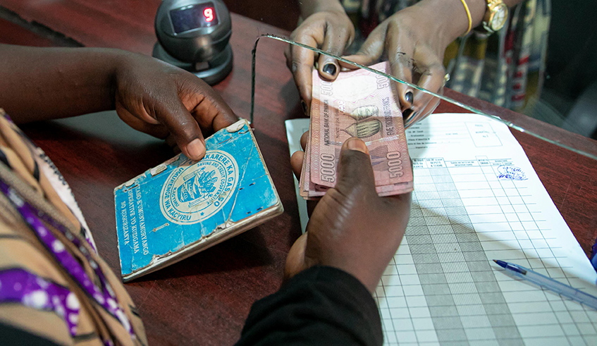 A customer gets her money at Kacyiru SACCO. / Photo: File.