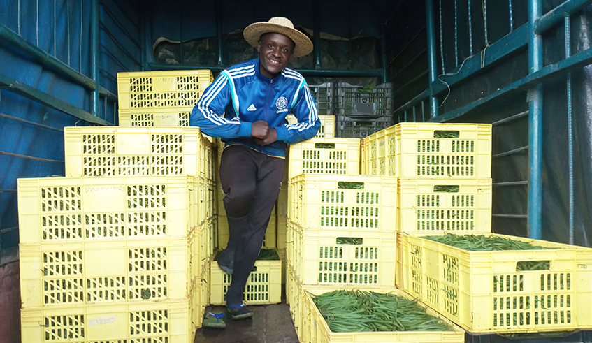 Dieudonnu00e9 Niyodushima, an agripreneur, poses with export crates of green beans in Bugesera District. / Photo: File.