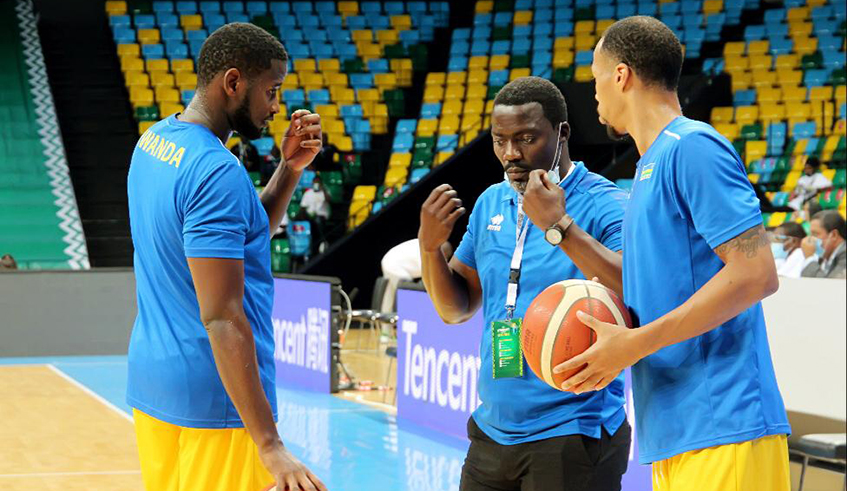 National Team's Assistant coach Henry Mwinuka gives instructions to team captain  Olivier Shyaka and Gasana during the warm-up at Kigali Arena  . / Courtesy