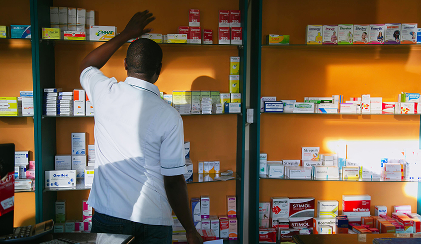 A pharmacist searches for medicine in Kigali. Some pharmacies and clinics have been accused of seeking to defraud theÂ RwandaÂ Social Security Board (RSSB) through prescription of unnecessary medicine and presenting higher bills  as well as billing for medical services that were never provided. / Photo: Craish Bahizi. 
