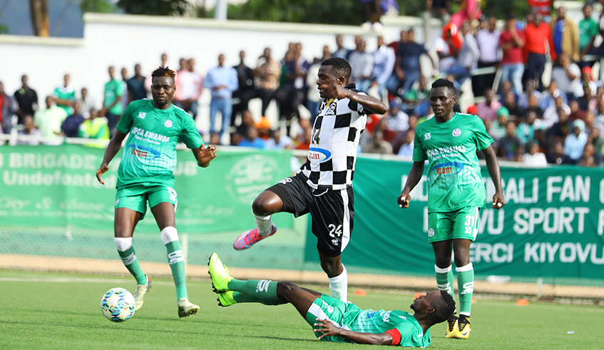 SC Kiyovu defenders attempt to stop APRu2019s Emmanuel Imanishimwe during a league match on March 10 at Kigali stadium. / Sam Ngendahimana