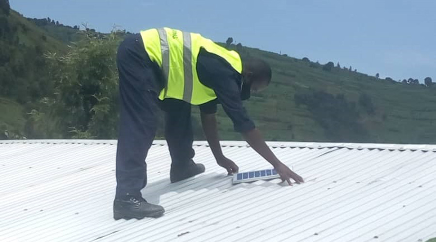 A Police officer installing solar power system in Gicumbi District.