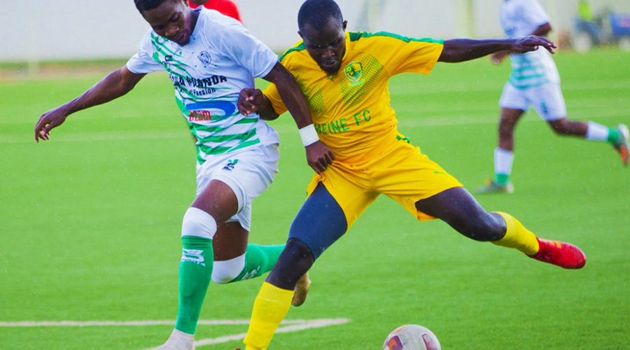 SC Kiyovu midfielder Moustapha Nsengiyumva and Marines FC defender Ramadhan Dusingizemungu during a league match at Kigali Stadium last week. 