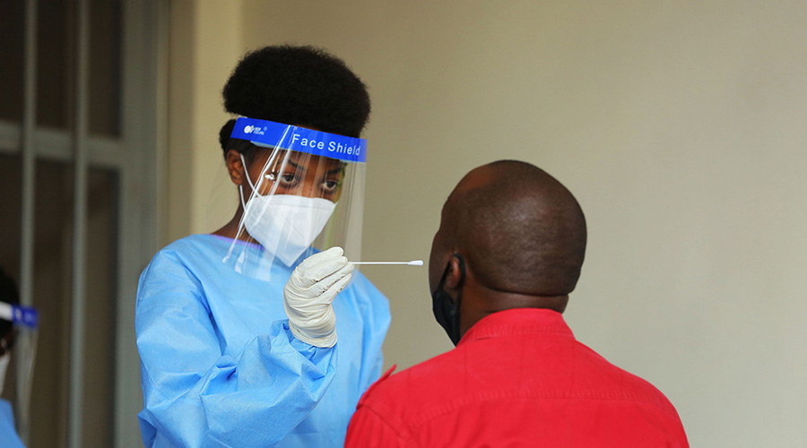 A health worker tests a Kigali resident for Covid-19 on August 17. 