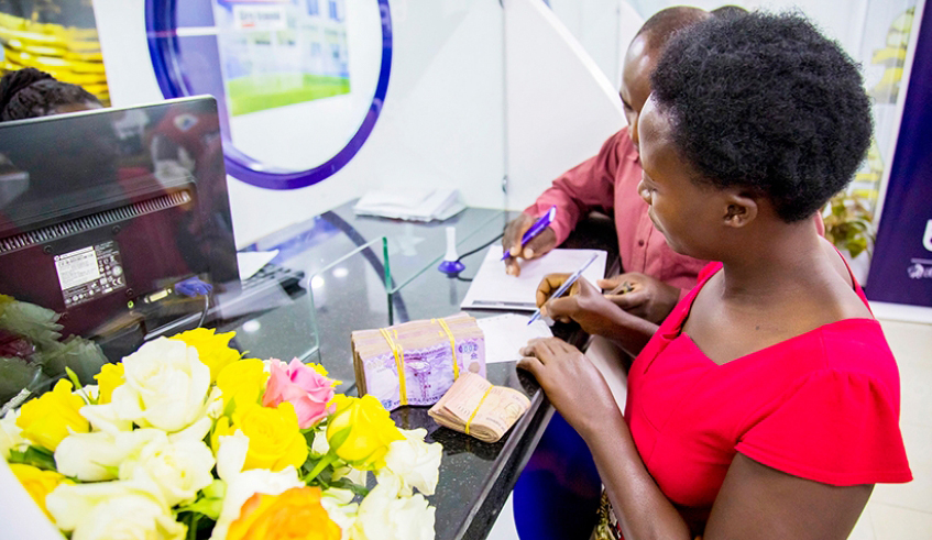 Banque Populaire du Rwanda Plc customers carry out transactions at the Nyabugogo Branch in Kigali in 2019. a big number of employees save through a bank saving account. / Photo: File.