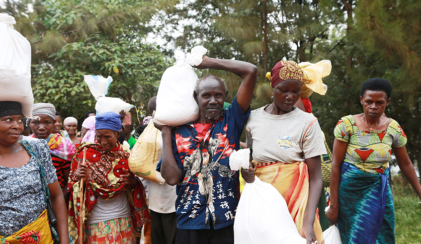 Citizens who were in the first category of Ubudehe carry foodstuff at Jali sector in Gasabo District in August last year. / Photo: Sam Ngendahimana.