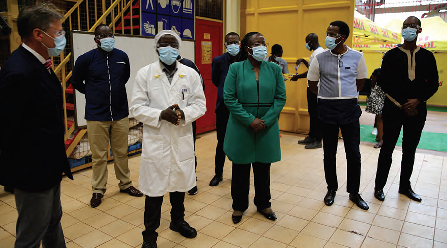 Managing Director of SKOL Breweries Limited, Ivan Wulffaert, (left) and Minister for Environment Jeanne du2019Arc Mujawamariya, (center) take a tour of the brewery during a recent official visit. 
