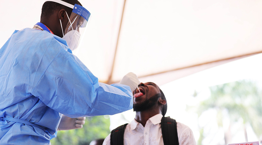 A health worker tests a Kigali resident for Covid19 recently. 