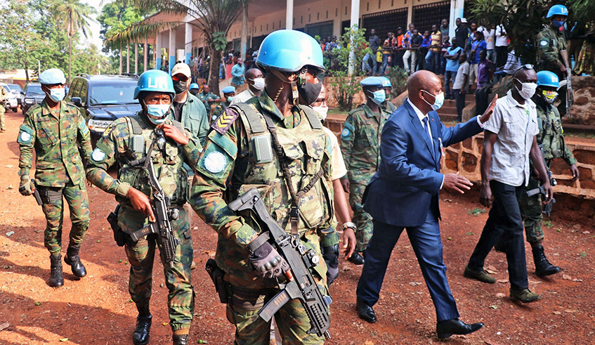 President Faustin-Archange Touadu00e9ra of Central African Republic is escorted by Rwandan peacekeepers as he arrives at a polling station to cast his ballot in the capital Bangui on Sunday, December 27, 2020. The CAR government has urged its citizens, especially those in the capital Bangui, to remain calm soon after government security forces and UN peacekeepers repulsed an attack by a rebel coalition. / Photo: Courtesy.  