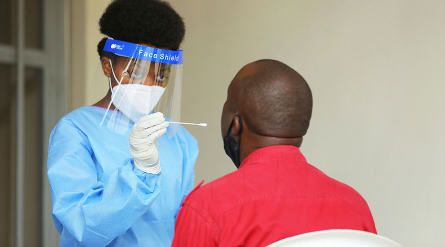 A health worker tests a Kigali resident for Covid-19 recently. The number of confirmed cases in Rwanda has crossed the 10,000-mark. 