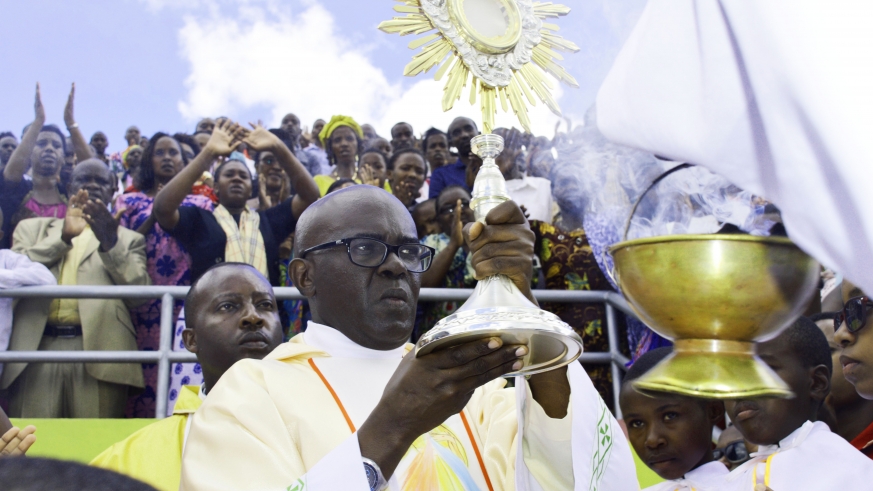 Father Ubald Rugirangoga leads holy communion at Amahoro National Stadium on April 10, 2016. 