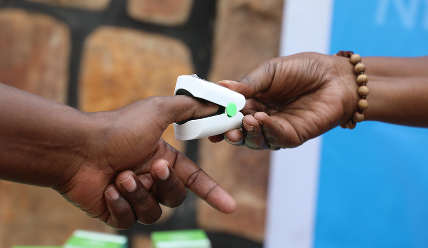 A pulse oximeter is used to detect blood oxygen levels, which experts say is a potential sign of Covid-19. The devices will largely be deployed in Covid-19 cases uder home-based care in Gasabo District, Kigali. / Photo: Craish Bahizi