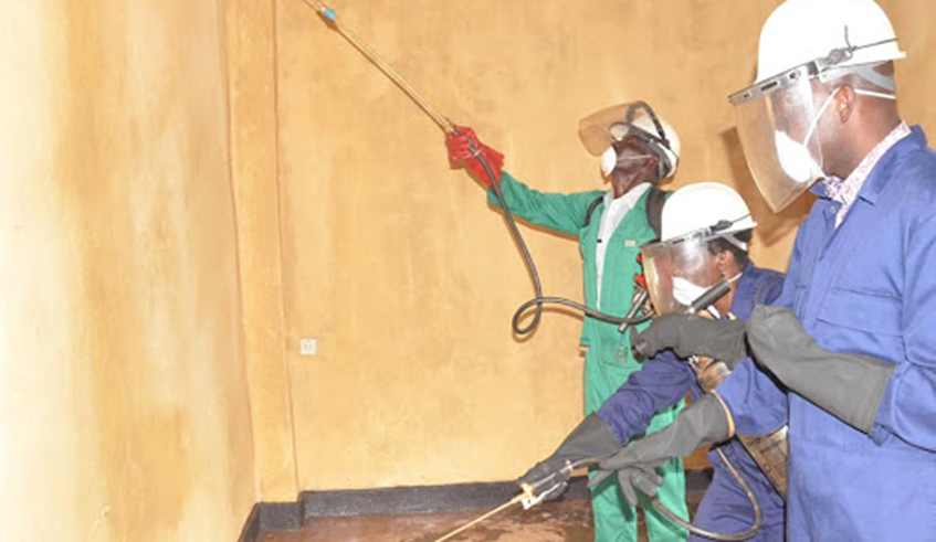 Workers carry out indoor residual spraying to eliminate malaria-causing mosquitoes in Huye District in 2016.  / Photo: File.
