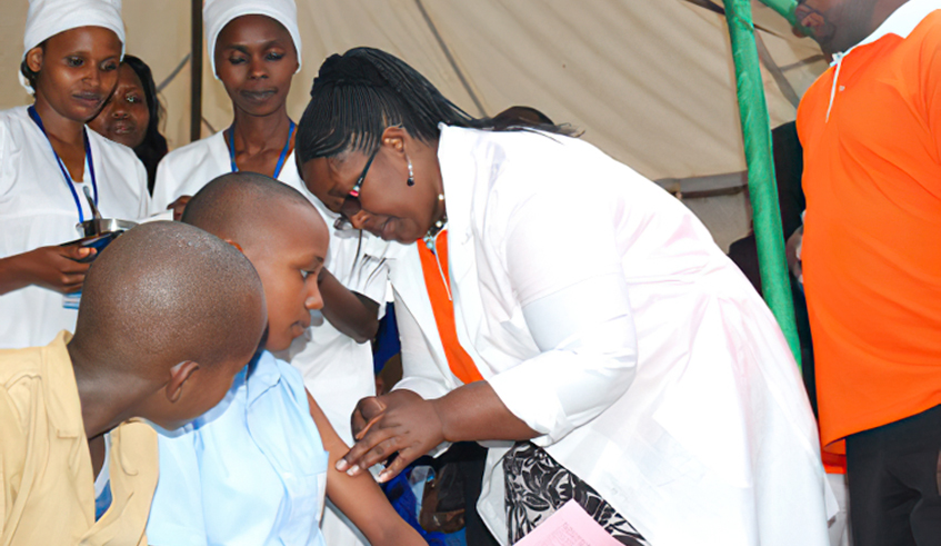 Health workers vaccinate schoolgirls against cervical cancer in Nyanza District in 2013. / Photo: File.  